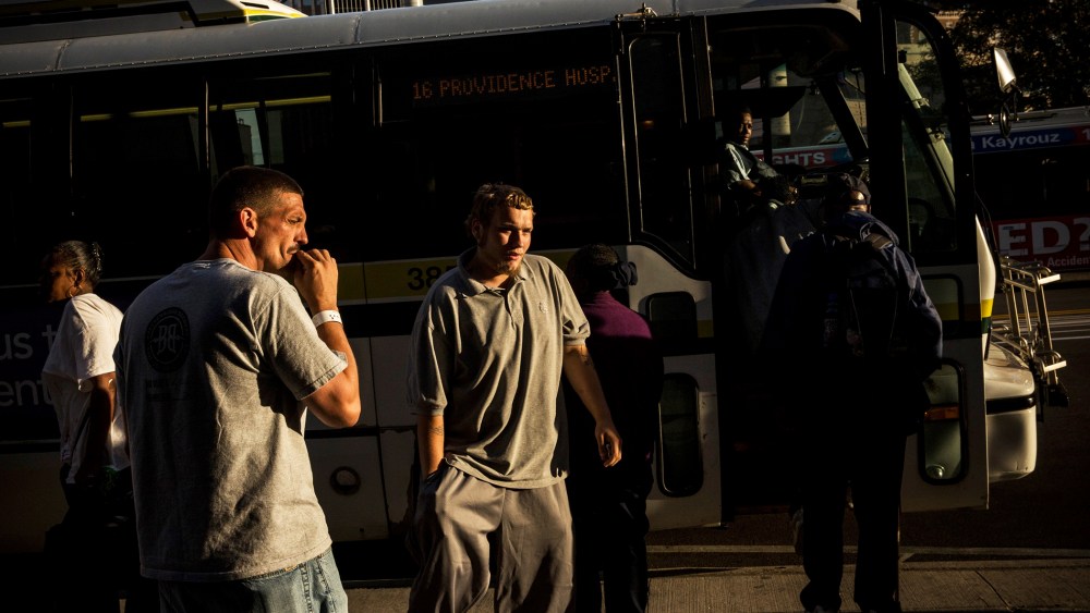 People board a public transit bus in Detroit, Michigan, Sept. 6, 2013.