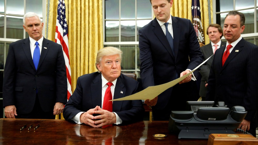 Image: FILE PHOTO: Porter hands document to Trump during signing ceremony in the Oval Office in Washington