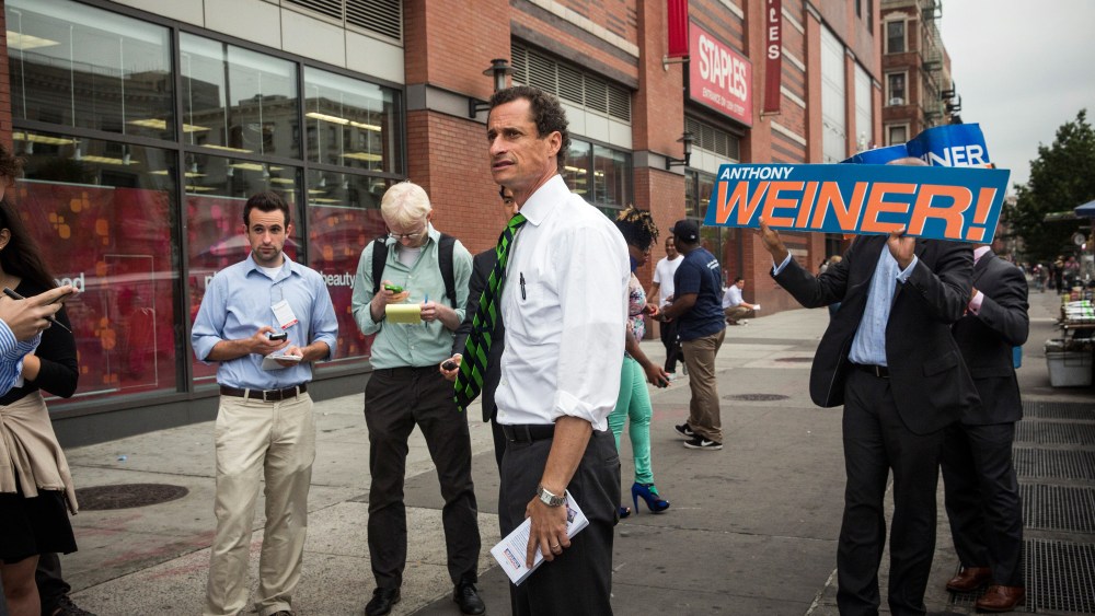 New York City mayoral hopeful Anthony Weiner meets with people on a street corner In Harlem on September 10, 2013 in New York City.