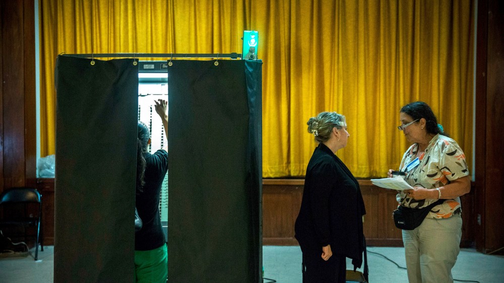 A woman votes at a polling station in New York City, Sept. 10, 2013.