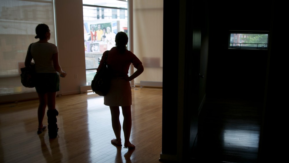 Image: Potential homebuyers look at a condominium for sale in Washington