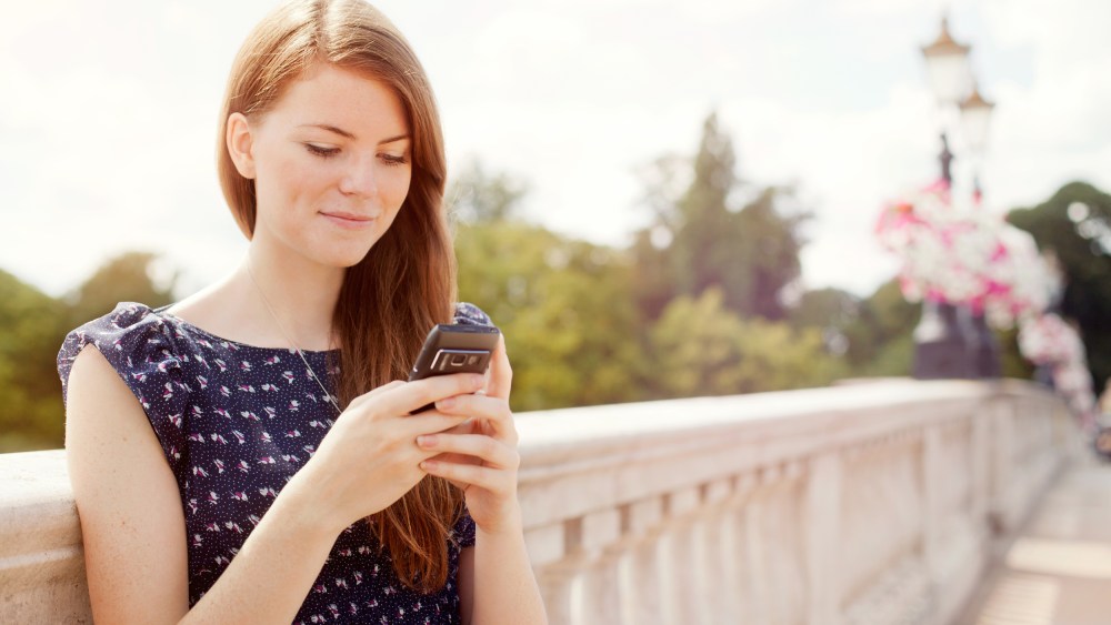 Image: A woman uses a mobile phone