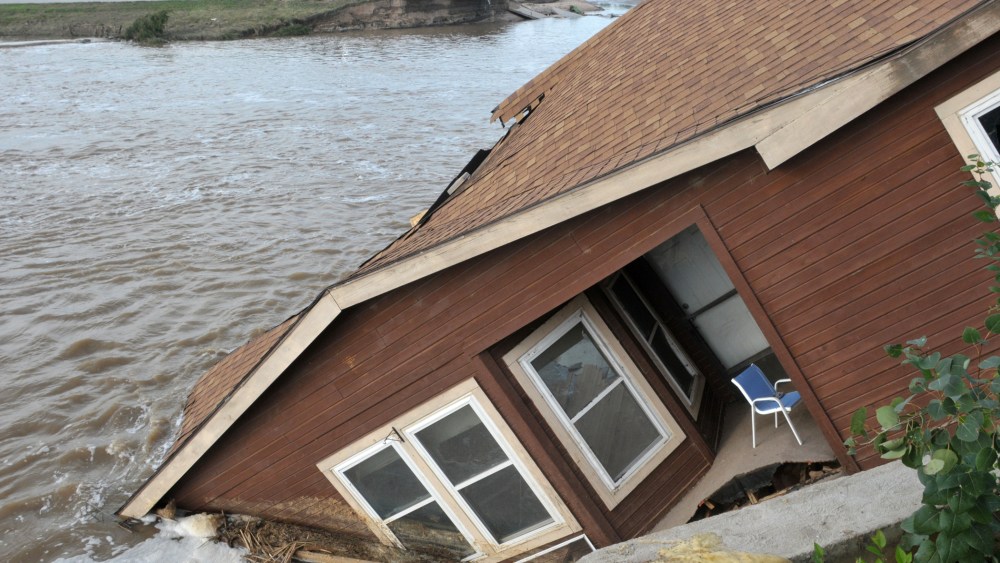 The home of a hired farm hand is shown collapsed near the South Platte River September 17, 2013 near Evans, in eastern Colorado.