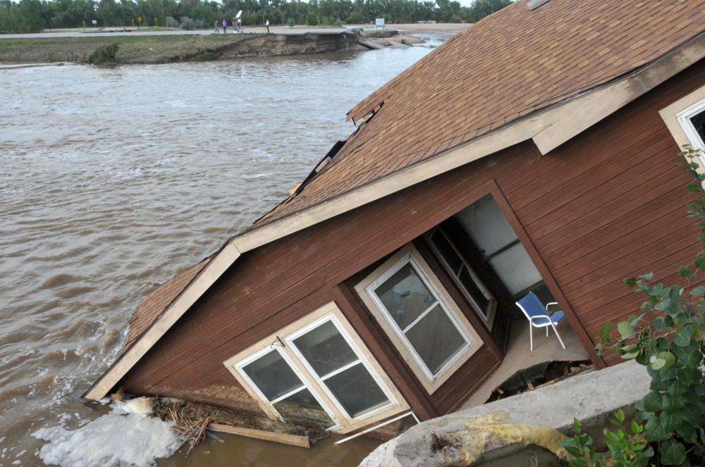The home of a hired farm hand is shown collapsed near the South Platte River September 17, 2013 near Evans, in eastern Colorado.