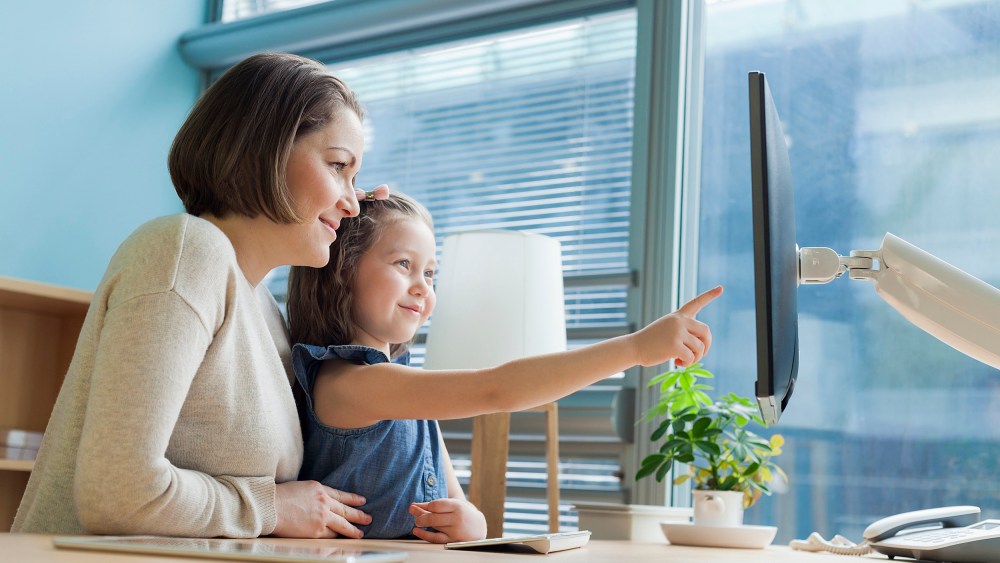 Image: Mother and daughter looking at work desk computer