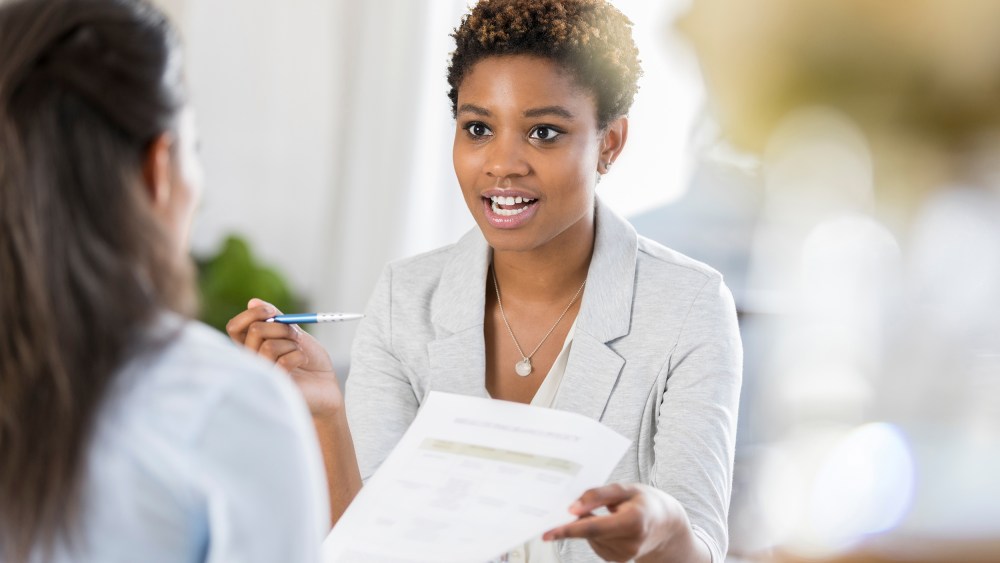 Businesswomen meet to discuss document