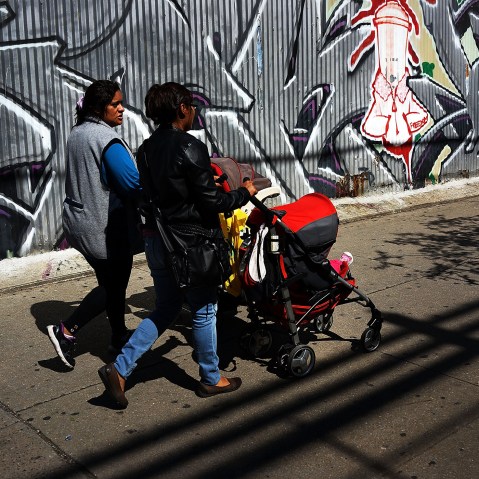 Two women walk down a street in the South Bronx, Sept. 19, 2013.