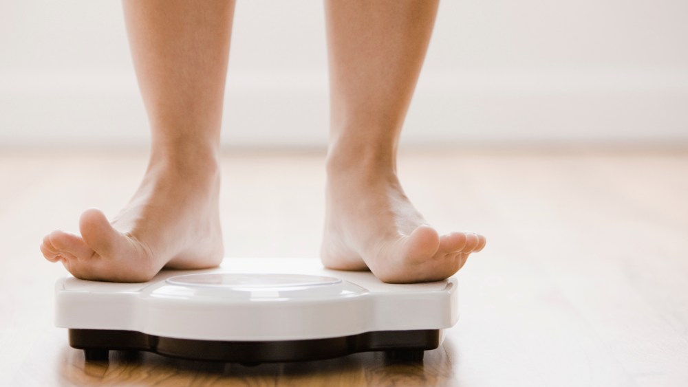 Woman's feet standing on scale