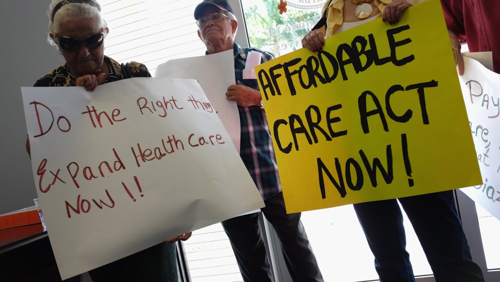 Leonor Cervantes (L) and other protesters gather in the office of Florida State Rep. Manny Diaz as they protest his stance against the expansion of healthcare coverage on September 20, 2013 in Miami, Florida.