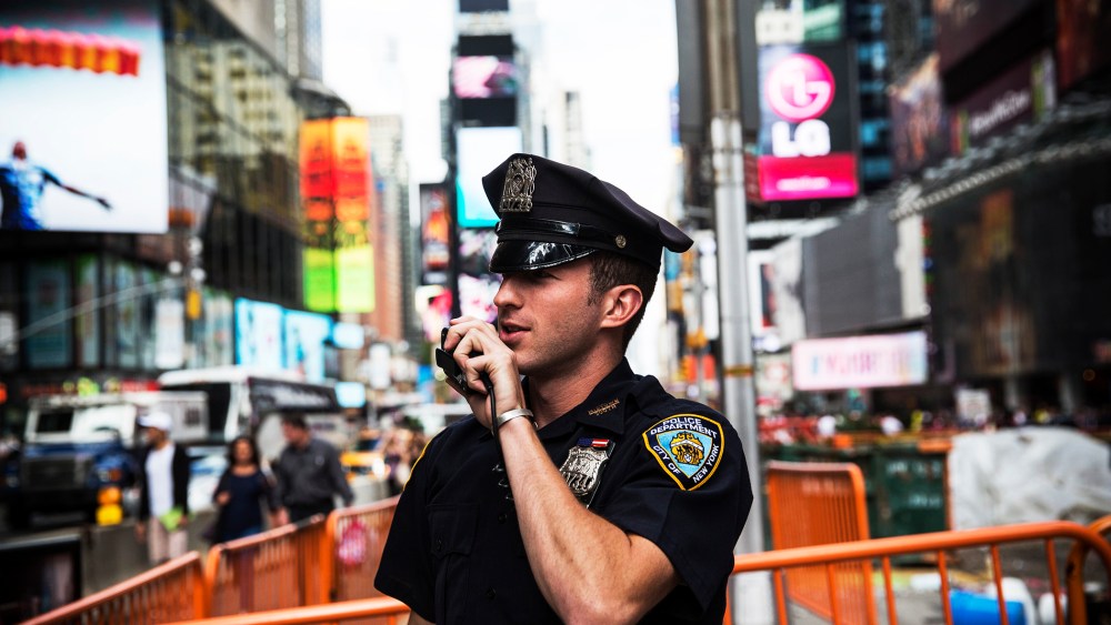 A New York Police Department officer speaks on his radio in Times Square, Sept. 22, 2013.