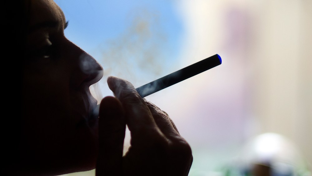 This Sept. 25, 2013 photo illustration taken in Washington, DC, shows a woman smoking an "Blu" e cigarette.