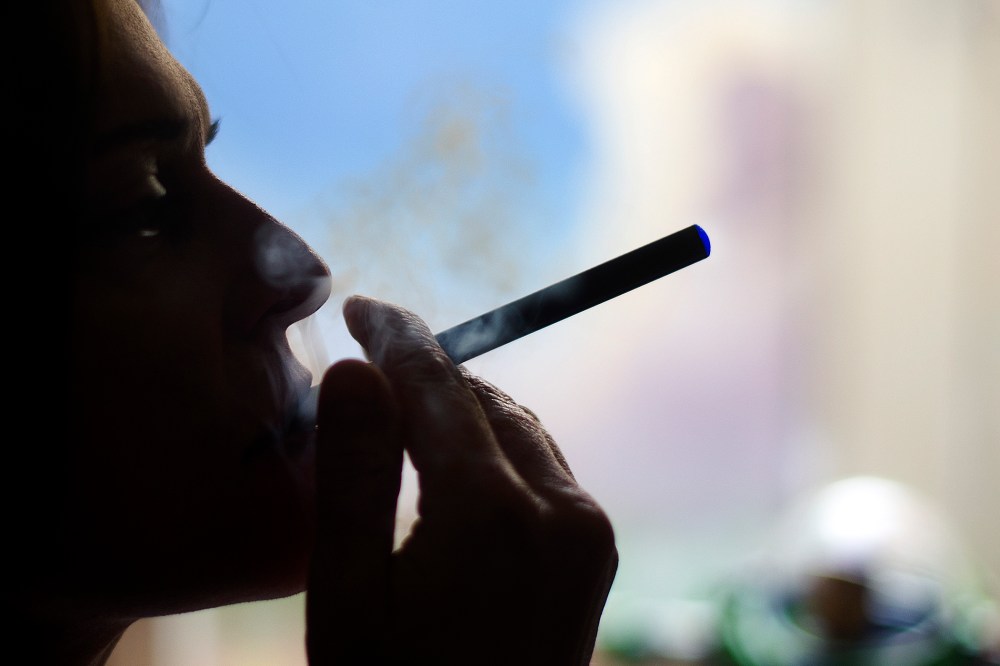 This Sept. 25, 2013 photo illustration taken in Washington, DC, shows a woman smoking an "Blu" e cigarette.