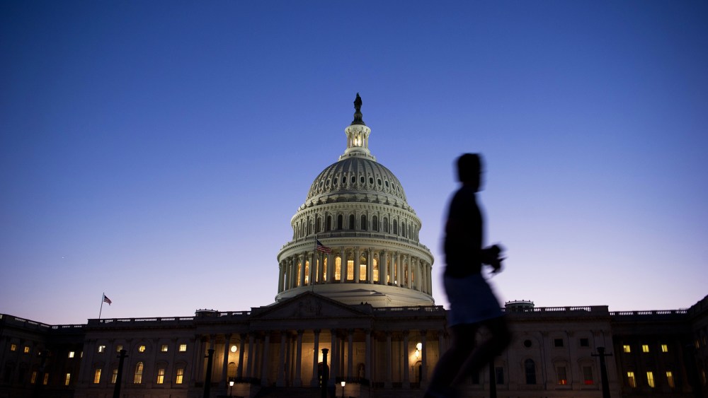 A man jogs past the U.S. Capitol in Washington, D.C., on Sept. 30, 2013.