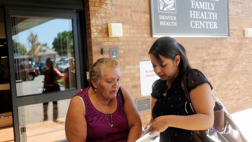 Lida Galindo talks with Mirian Morales,about the Affordable Care Act outside of the Denver Health Westside Family Health Center on October 01, 2013 in Colorado.