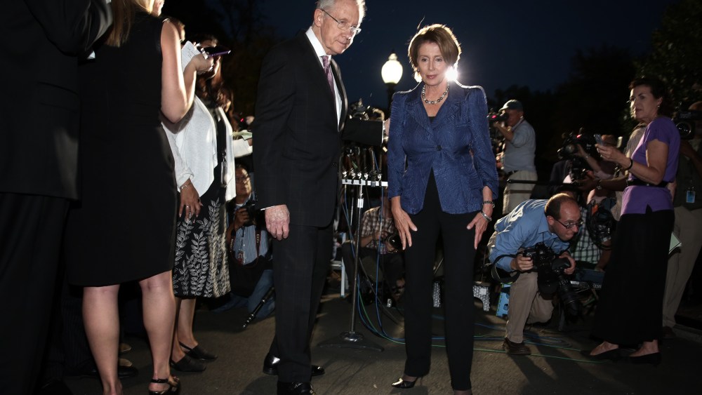 U.S. Senate Majority Leader Sen. Harry Reid (D-NV) (L) and House Minority Leader Rep. Nancy Pelosi (D-CA) (R) leave after a meeting with President Barack Obama October 2, 2013 at the White House in Washington, DC.