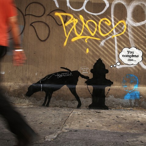 A new Bansky work on a side of a wall is viewed on Oct. 3, 2013 in New York City.