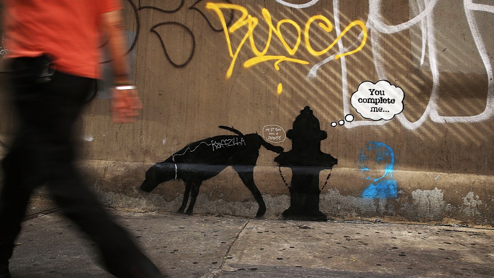 A new Bansky work on a side of a wall is viewed on Oct. 3, 2013 in New York City.