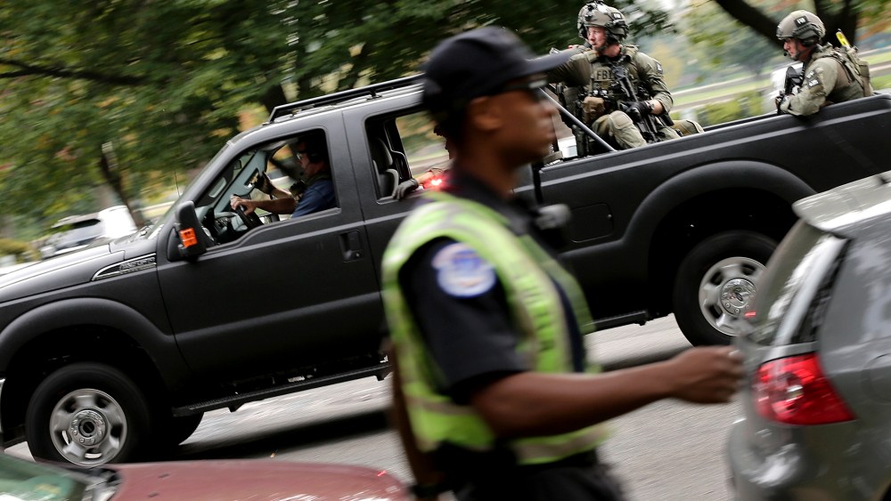FBI agents in SWAT gear respond to an incident on Constitution Avenue outside the U.S. Capitol Oct. 3, 2013 in Washington.
