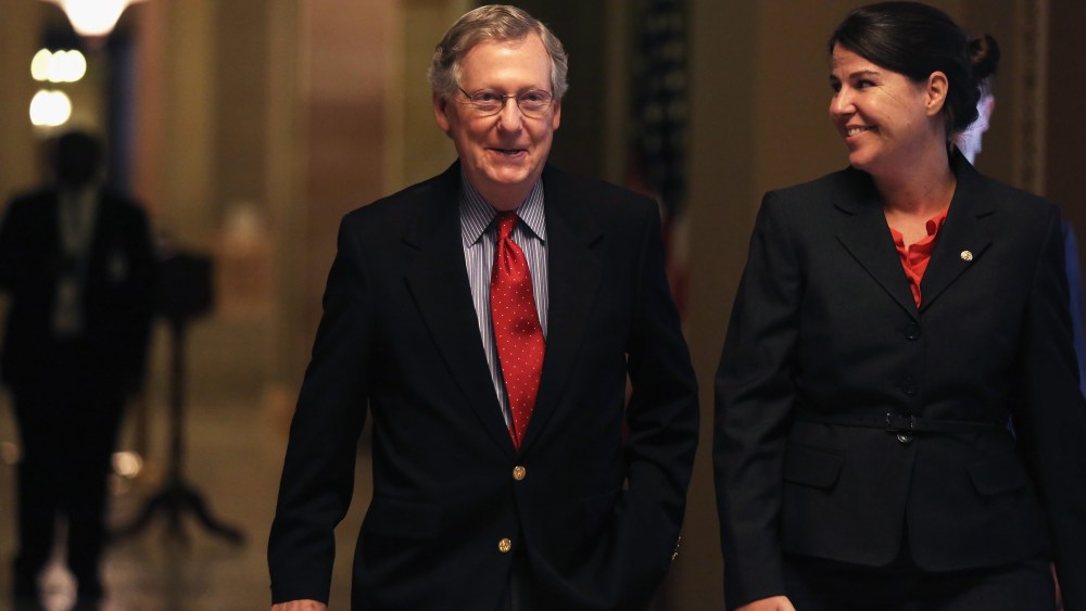 U.S. Minority Leader Senator Mitch McConnell (R-KY) walks towards the Senate Chamber with Secretary of the Minority Laura Dove October 7, 2013
