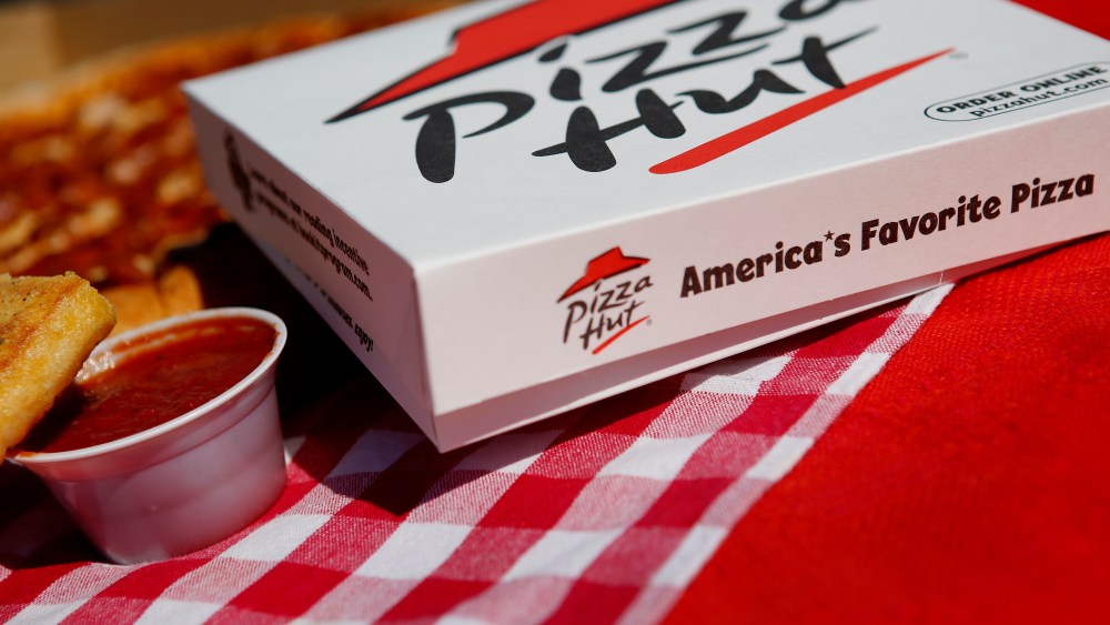 Breadsticks and a pepperoni pizza from a Pizza Hut restaurant.