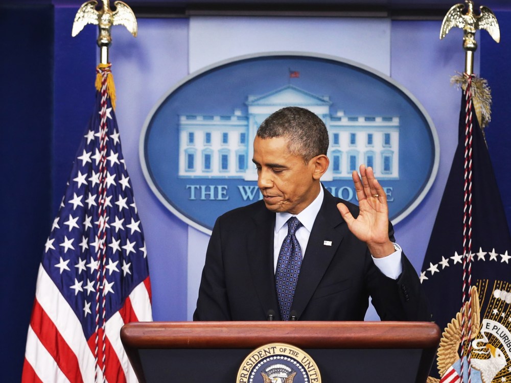 President Barack Obama waves at the conclusion of a press conference in the Brady Press Briefing Room of the White House on October 8, 2013 in Washington, DC.