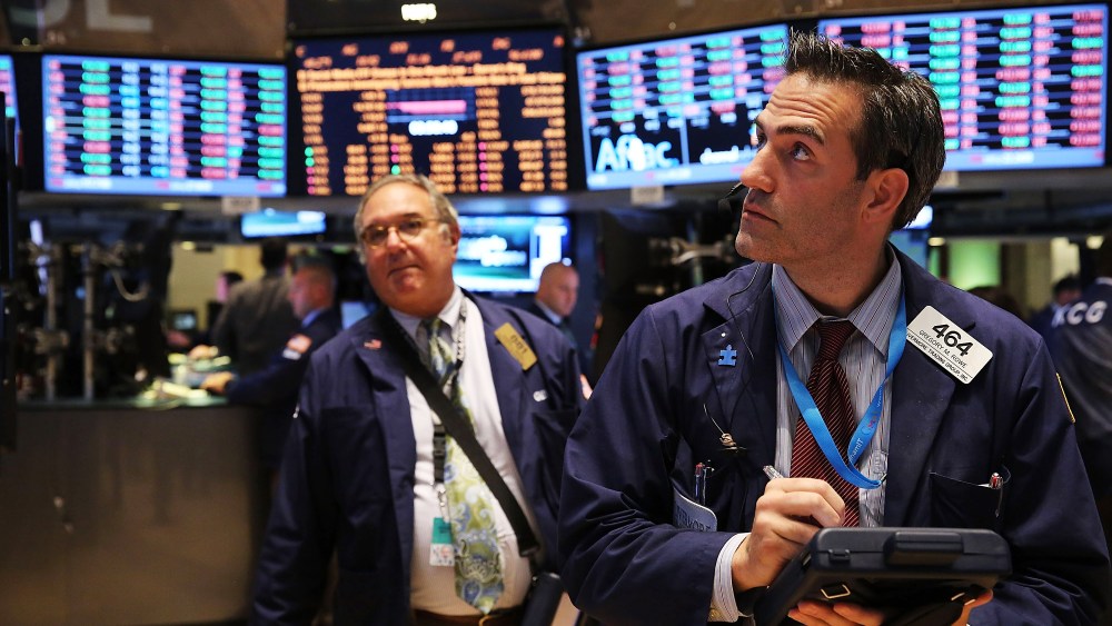 Traders work on the floor of the New York Stock Exchange minutes before the closing bell on October 8, 2013 in New York City.