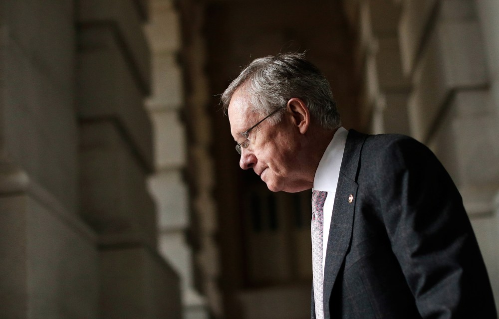 Senate Majority Leader Harry Reid (D-NV) walks to an event with Democratic senators on the steps U.S. Capitol October 9, 2013 in Washington, DC.