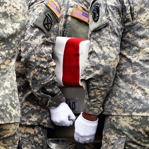 U.S. Army soldiers carry the flag-draped transfer case containing the remains of U.S. Army Pfc. Cody J. Patterson during a dignified transfer at Dover Air Force Base on October 9, 2013 in Dover, Delaware.