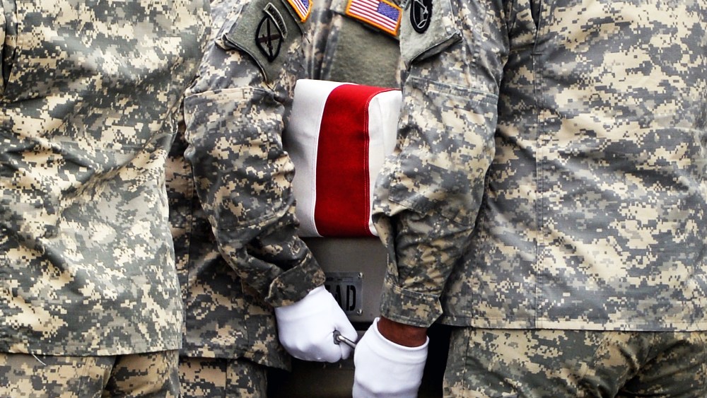 U.S. Army soldiers carry the flag-draped transfer case containing the remains of U.S. Army Pfc. Cody J. Patterson during a dignified transfer at Dover Air Force Base on October 9, 2013 in Dover, Delaware.
