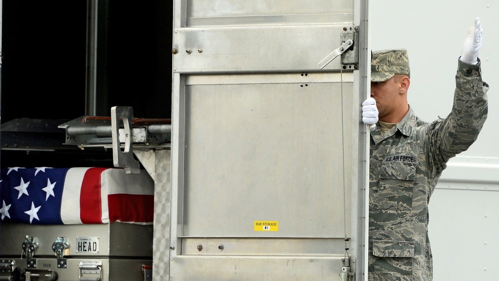 U.S. Army soldiers carry the flag-draped transfer case containing the remains of U.S. Army Pfc. Cody J. Patterson during a dignified transfer at Dover Air Force Base on October 9, 2013 in Dover, Delaware.