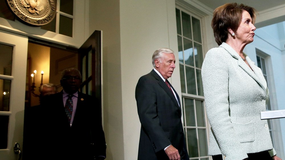 House Minority Leader Nancy Pelosi (D-CA) (R) leaves the White House with Rep. Steny Hoyer (D-MD) following a meeting between U.S. Presiden Barack Obama and members of the House Democratic leadership October 9, 2013 in Washington, DC.