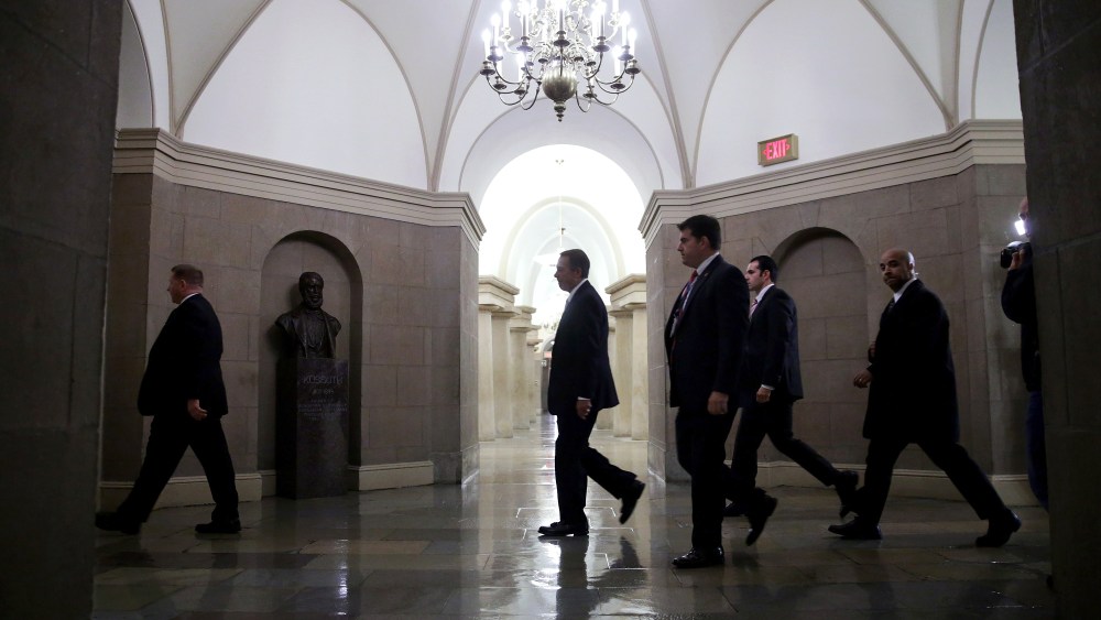 Speaker of the House John Boehner is surrounded by U.S. Capitol Police plainclothes officers as he arrives at the U.S. Captiol October 11, 2013 in Washington, DC.