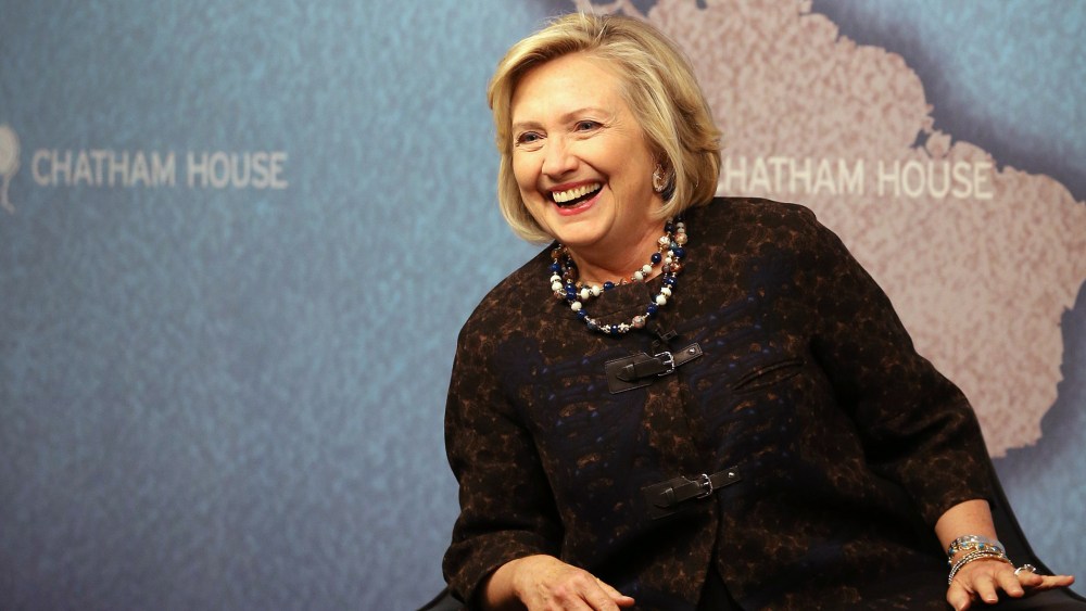 Former US Secretary of State Hillary Clinton smiles as she waits to answer questions from an audience at Chatham House on Oct. 11, 2013 in London, England.