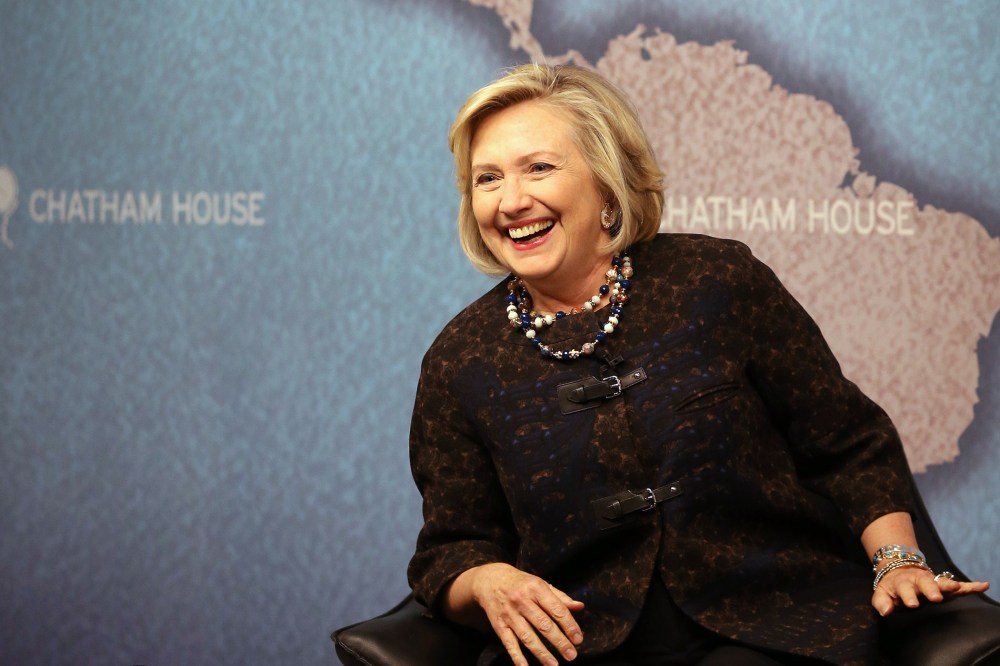 Former US Secretary of State Hillary Clinton smiles as she waits to answer questions from an audience at Chatham House on Oct. 11, 2013 in London, England.