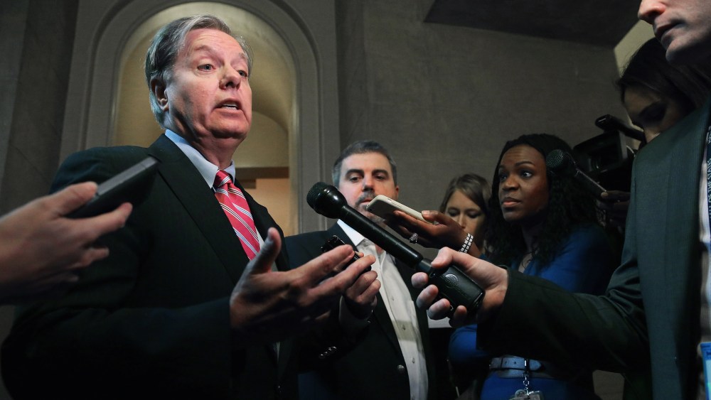 Sen. Lindsey Graham (R-SC) talks to reporters after leaving a Senate Republican caucus meeting at the U.S. Capitol on Oct. 11, 2013 in Washington, DC.