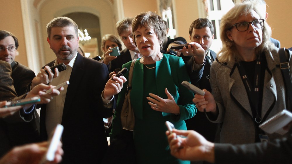 Sen. Susan Collins (R-ME) (C) talks to reporters after leaving a Senate Republican caucus meeting at the U.S. Capitol on Oct. 11, 2013 in Washington, DC.