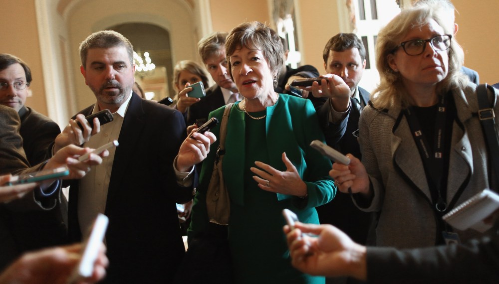 Sen. Susan Collins (R-ME) (C) talks to reporters after leaving a Senate Republican caucus meeting at the U.S. Capitol on Oct. 11, 2013 in Washington, DC.