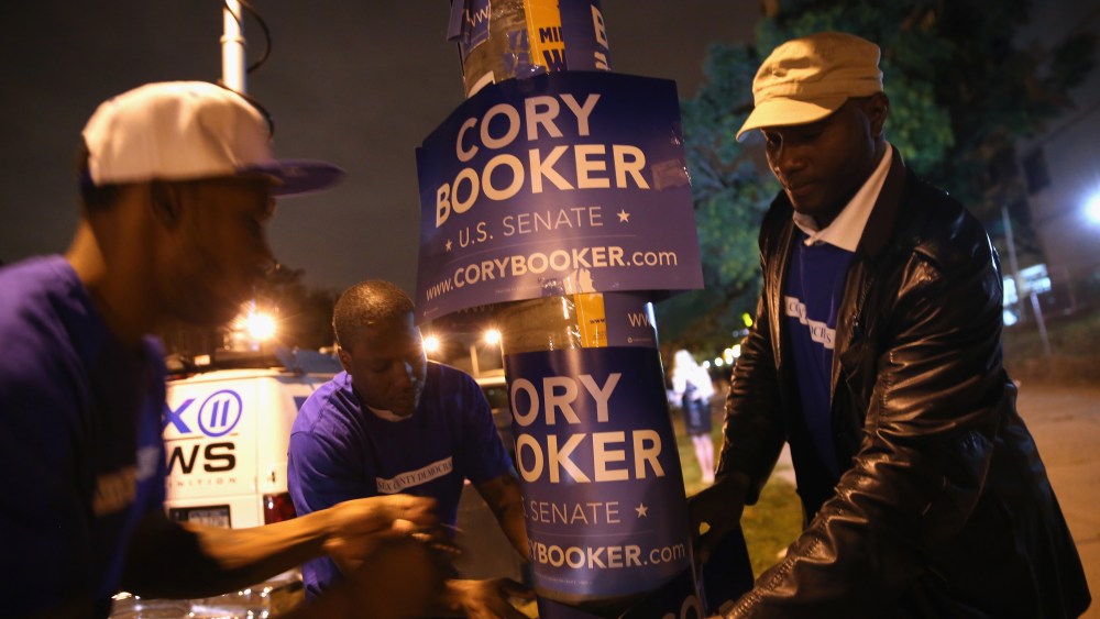 Campaign workers for Newark Mayor Cory Booker put up signs outside a polling station  for a special U.S. Senate election on October 16, 2013 in Newark, New Jersey.