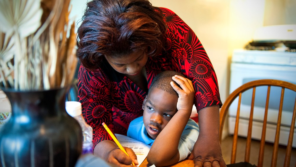 Monique Henderson helps her son, Geramiah, 8, with his homework after school in Camp Springs, MD, Oct. 15, 2013.