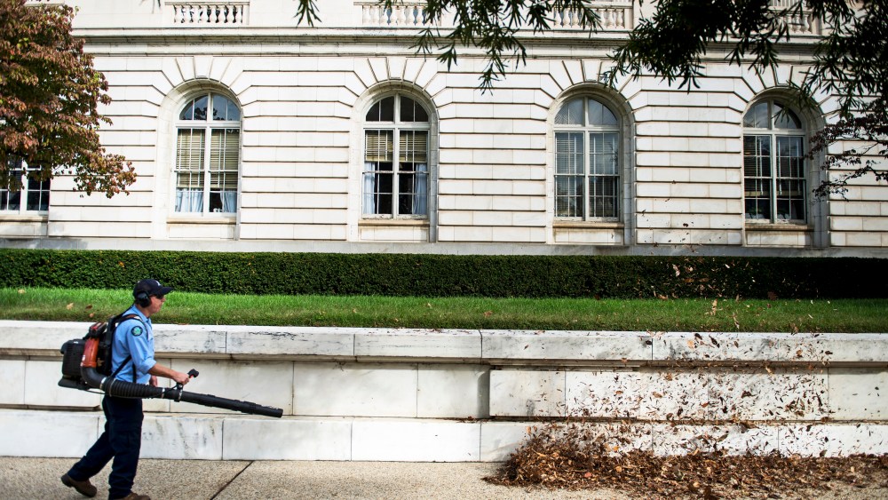 A worker cleans leaves from the Russell Senate Office Building on Capitol Hill October 17, 2013 in Washington, DC.