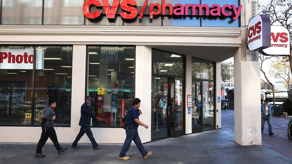 Pedestrians walk by a CVS store in San Francisco, Calif., Nov. 5, 2013.