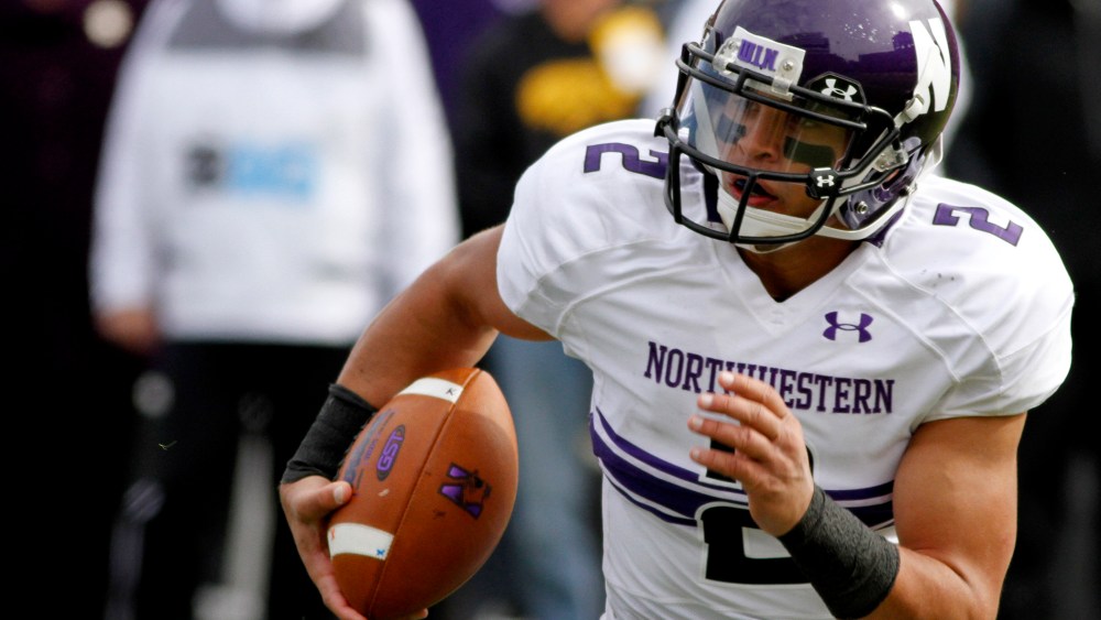 Quarterback Kain Colter of the Northwestern Wildcats plays against the Iowa Hawkeyes on Oct. 26, 2013 at Kinnick Stadium in Iowa City, Iowa.