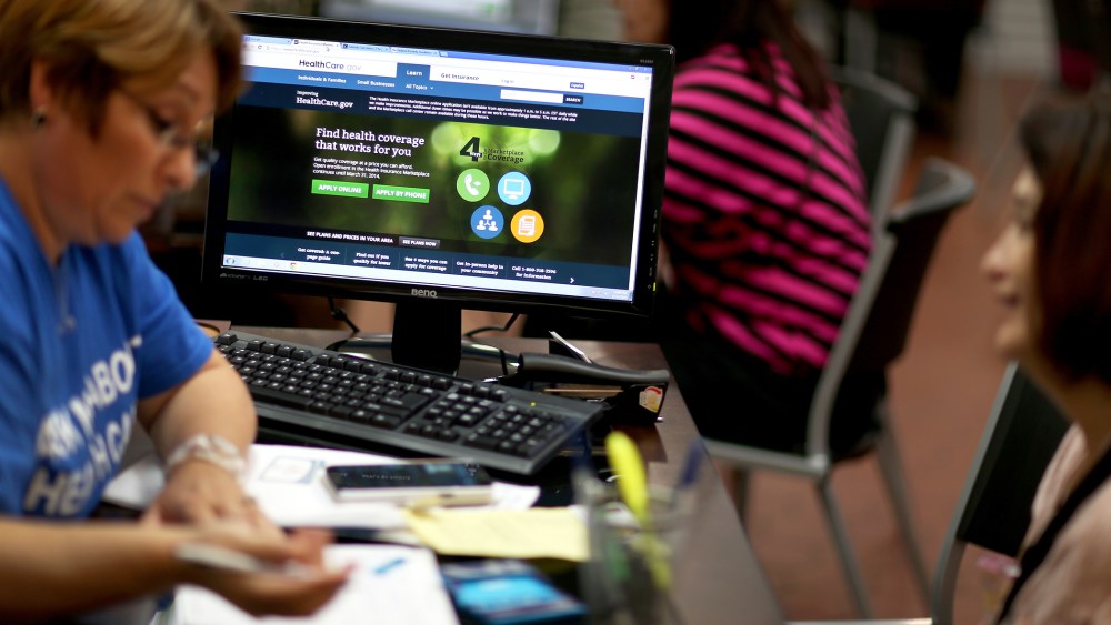 Mercy Cabrera (L), an insurance agent with Sunshine Life and Health Advisors, helps Amparo Gonzalez purchase an insurance policy under the Affordable Care Act at the store setup in the Westland Mall on Nov. 14, 2013 in Hialeah, Fla.