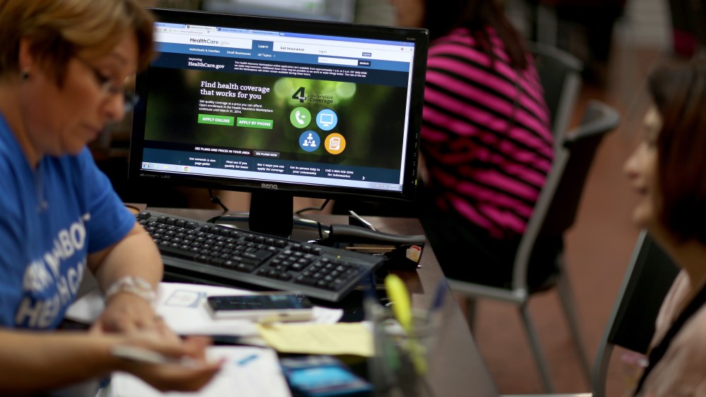 An insurance agent helps Amparo Gonzalez purchase an ACA insurance policy in Hialeah, Fla., Nov. 14, 2013.