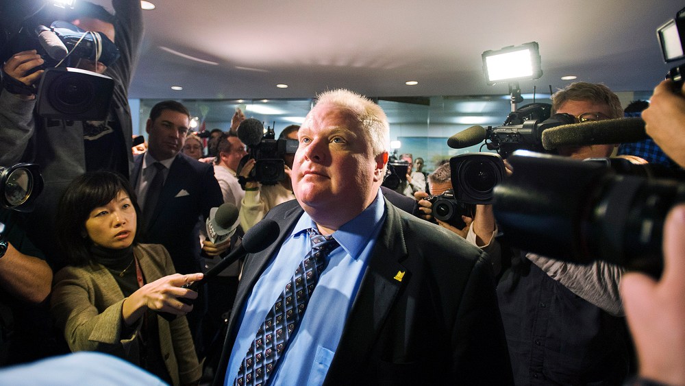Toronto Mayor Rob Ford stands amid the media at City Hall after City Council some management powers on Nov.15, 2013 in Toronto, Canada.