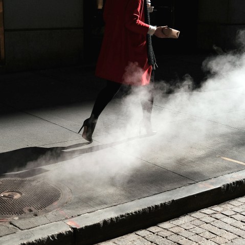 Image:  A woman walks on Wall Street in New York on March 21, 2016.