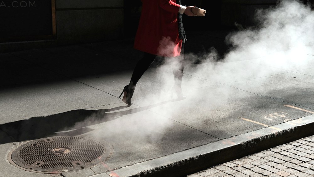 Image:  A woman walks on Wall Street in New York on March 21, 2016.