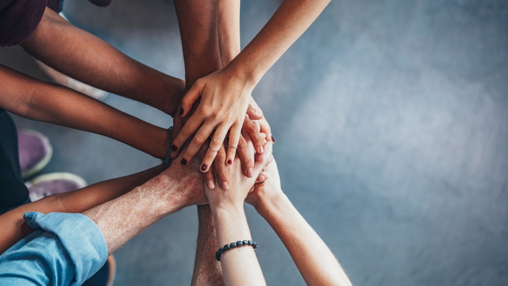 Stack of hands showing unity