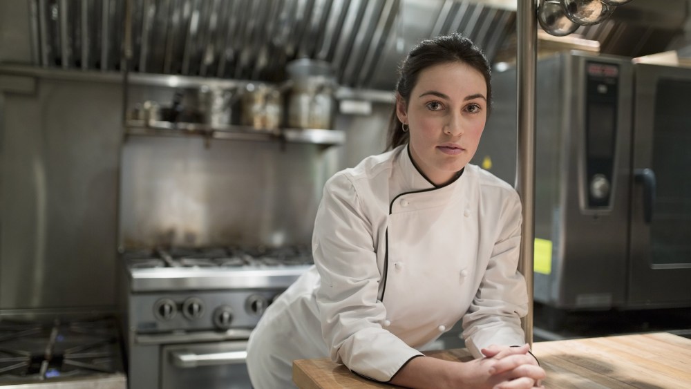 Image: A female chef in restaurant kitchen