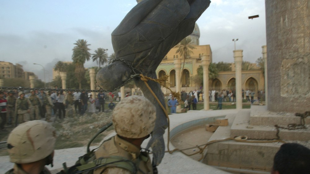 File Photo: U.S. Marines from the Marine 1st Division take down a Saddam Hussein statue April 9, 2003 in Baghdad, Iraq. (Photo by Robert Nickelsberg/Getty Images, File)